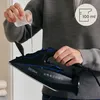 A person is pouring water into an iron. Produktbild-Vorschau