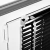 A close-up view of a black aluminum blind attached to a white window frame. Produktbild-Vorschau
