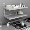 A kitchen scene with shelves holding plates, bowls, and cookware, and a stove in the foreground. Produktbild-Vorschau
