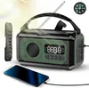 A survival radio is shown with a smartphone charging from it, and a compass is visible in the background. Podgląd zdjęcia produktu