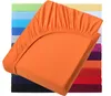 A stack of colorful fitted sheets, with the top one in orange prominently displayed. Produktbild-Vorschau