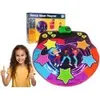 A young girl is shown giving a thumbs up next to a colorful dance mat and its packaging. Náhled obrázku produktu