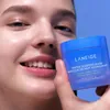 A woman is holding a Laneige Water Sleeping Mask in front of her face, smiling. Náhľad obrázku produktu