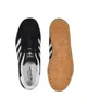 A top-down view of a pair of Adidas Gazelle sneakers, one shoe showing the interior and the other showing the sole. Produktbild-Vorschau