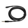 A black audio cable with a 3.5mm jack on one end and a micro USB connector on the other, coiled on a white background. Podgląd zdjęcia produktu