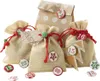 A collection of small burlap bags decorated with festive buttons and tags, arranged on a white background. Anteprima dell’immagine prodotto
