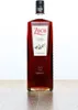 A bottle of Zoco Pacharan liqueur stands on a wooden surface against a white background. Voir les images du produit