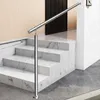 A silver stainless steel handrail is installed on marble stairs, leading to a dark door. Produktbild-Vorschau