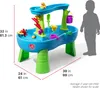 A child's water table with dimensions indicated by measurement lines and text. A silhouette of a child is shown for scale. Produktbild-Vorschau