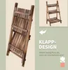 A folded wooden plant stand is shown on the left, and an unfolded plant stand is shown in a smaller inset image on the upper right. Text and an arrow indicate the folding feature. Produktbild-Vorschau