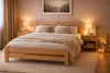A cozy bedroom scene with a wooden bed as the focal point, decorated with soft lighting and warm textiles. Produktbild-Vorschau