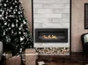 A modern living room with a fireplace, Christmas tree, and gifts. Anteprima dell’immagine prodotto