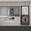 A laundry room with a washing machine and dryer stacked, a sink, and storage cabinets. Náhled obrázku produktu