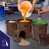 Several buckets are shown, some filled with liquids and one with sand. A brush is dipping into a green liquid in one bucket. A person is pouring orange liquid into another bucket. Voir les images du produit