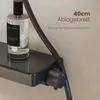 A close-up of a shower system with a shelf holding a bottle of home spray, with text overlays indicating product features. Produktbild-Vorschau