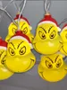 A close-up of several Grinch-themed Christmas lights. Produktbild-Vorschau