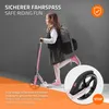 A young girl riding a pink scooter indoors, with a close-up of the scooter's wheel and brake system. Náhľad obrázku produktu