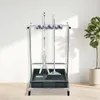 A cleaning tool organizer stand with a mop and broom on it, placed against a white wall with a plant in a pot to the right. Podgląd zdjęcia produktu