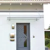 A glass canopy over a gray front door with mailboxes on the wall. Anteprima dell’immagine prodotto