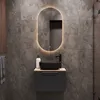 A modern bathroom vanity with a black sink and faucet, set against a gray tiled wall. Produktbild-Vorschau