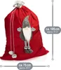 A red Christmas sack with a gnome decoration and size indicators. Produktbild-Vorschau