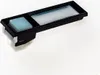 A close-up studio shot of a black electronic component with a light blue button and a translucent rectangular display area, set against a white background. Produktbild-Vorschau
