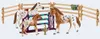 A set of toy horses and accessories in a stable-like setting. Produktbild-Vorschau