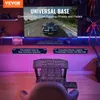 A gaming setup with a racing wheel stand, monitor, and gaming chair, illuminated by purple LED lights. Produktbild-Vorschau