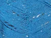 Close-up of blue yarn with white and black flecks. Produktbild-Vorschau
