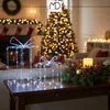 A festive indoor Christmas scene with decorated tree, stockings, and illuminated gift decorations. Podgląd zdjęcia produktu