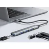 A USB hub connected to a laptop, with other USB devices nearby. Produktbild-Vorschau