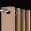 Close-up of beige curtains with metal grommets hanging on a silver rod against a black background. Produktbild-Vorschau