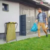 A man is taking out the trash on a sunny day. Anteprima dell’immagine prodotto