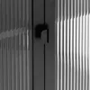 A close-up view of a black sideboard with ribbed glass doors and black metal handles. Produktbild-Vorschau