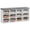 A white shoe rack with a gray cushion on top, filled with various types of women's shoes. Náhled obrázku produktu
