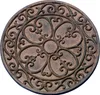 A round, decorative stepping stone with an ornate, wrought-iron-like pattern. Produktbild-Vorschau