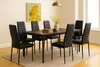 A dining room set with a table and chairs, decorated with a painting and flowers. Produktbild-Vorschau