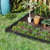 A garden scene with a raised garden bed, plants, and gardening accessories. Voir les images du produit