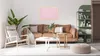 A living room scene with a sofa, chair, coffee table, and a green shelving unit. Anteprima dell’immagine prodotto
