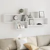 A white modular wall shelf unit mounted on a white wall above a sofa. Náhled obrázku produktu