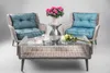 Two outdoor chairs and a coffee table set up for a relaxed setting. Produktbild-Vorschau
