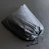 A black grill cover is shown on a dark surface. Náhľad obrázku produktu