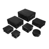 A collection of black electrical junction boxes of various sizes arranged on a white background. Voir les images du produit