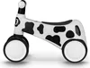 A white and black cow-print balance bike on a white background. Náhled obrázku produktu