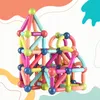 A colorful magnetic building block structure resembling a castle or house, set against a white background with abstract colorful shapes. Náhled obrázku produktu