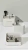 Three white cosmetic organizers are displayed against a light gray and white background. Náhled obrázku produktu