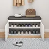 A shoe cabinet with a bench on top, filled with shoes and a handbag on the bench. Anteprima dell’immagine prodotto