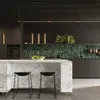 A modern kitchen with a marble island and green tiled backsplash. Voir les images du produit