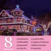 A house decorated with colorful Christmas lights at night. Produktbild-Vorschau