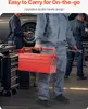 Three mechanics in a workshop, one is holding a red toolbox. Podgląd zdjęcia produktu